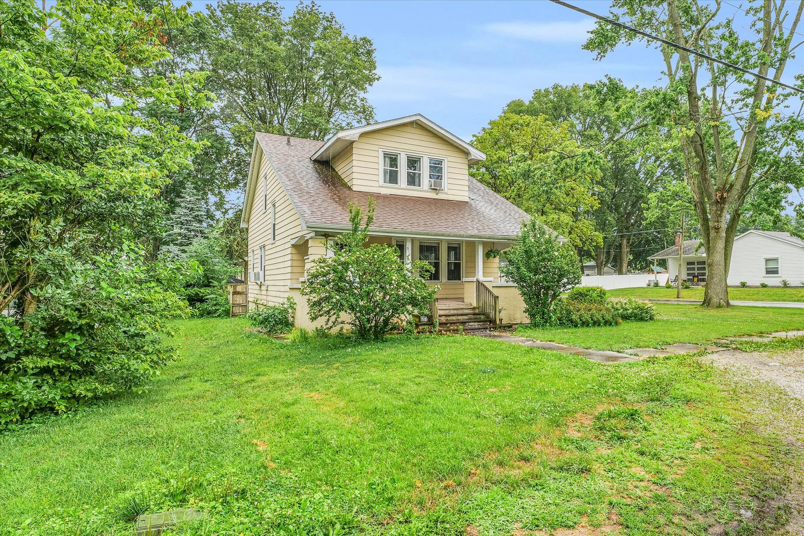 a front view of a house with a garden