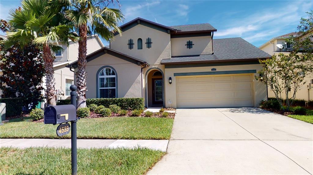 a front view of a house with a yard and garage