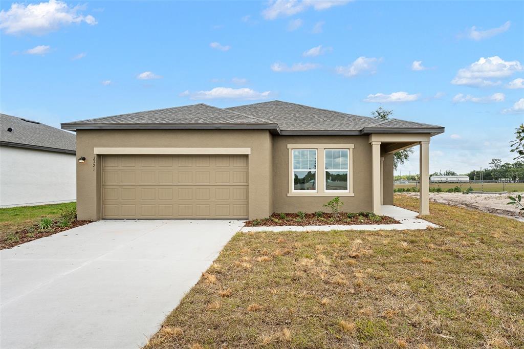 a front view of a house with a yard and garage