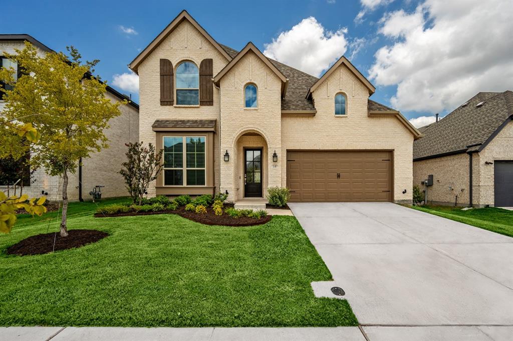 a front view of a house with a yard and garage