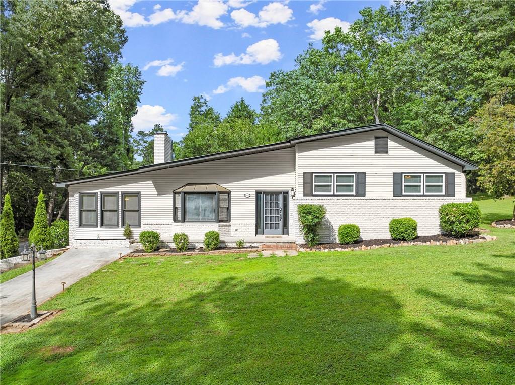 a front view of house with yard and green space