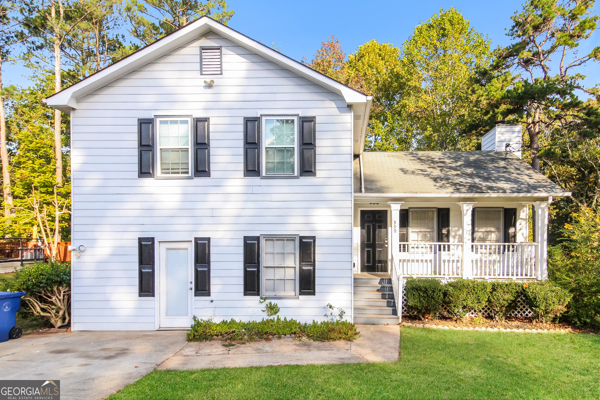 a front view of a house with a yard and porch