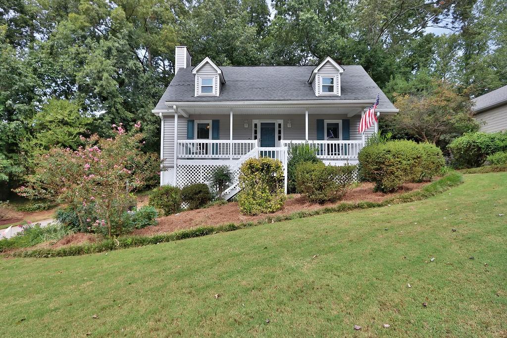 a front view of house with yard and green space