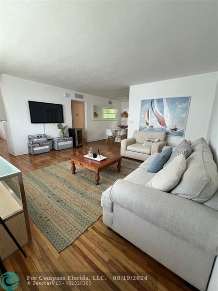 a bedroom with furniture and a flat screen tv