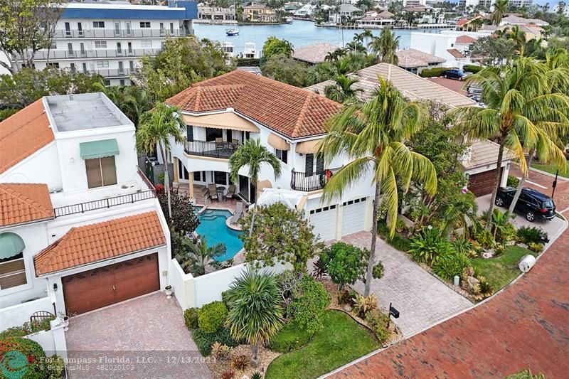 an aerial view of a house with garden space and street view