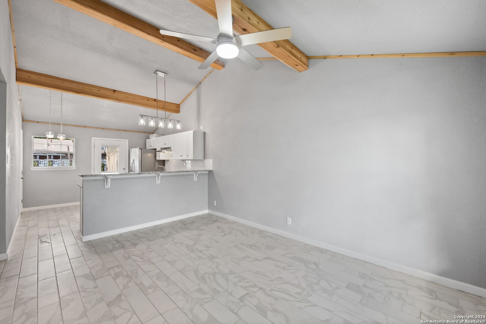 a view of a kitchen with a sink and cabinets