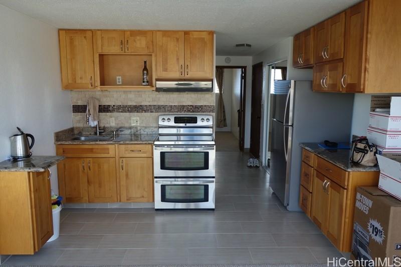 a kitchen with stainless steel appliances a stove a sink and a refrigerator