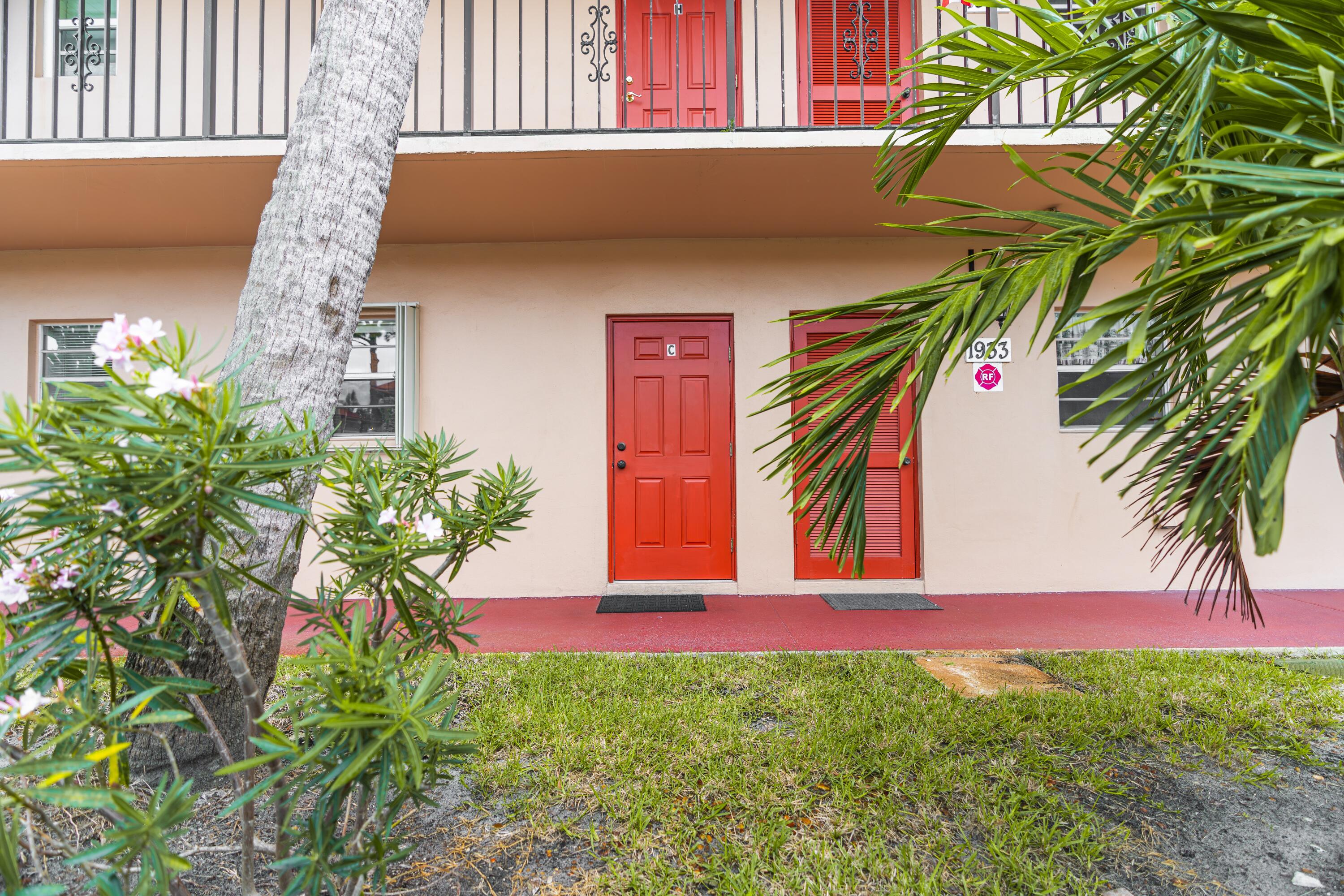 a view of a house with a small yard and a plant