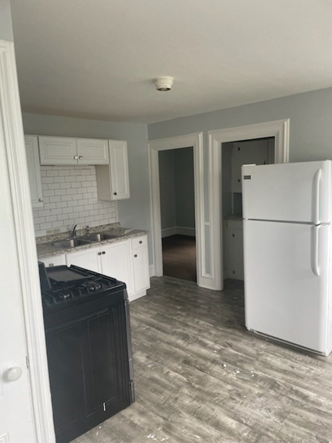 a kitchen with a refrigerator sink stove and cabinets