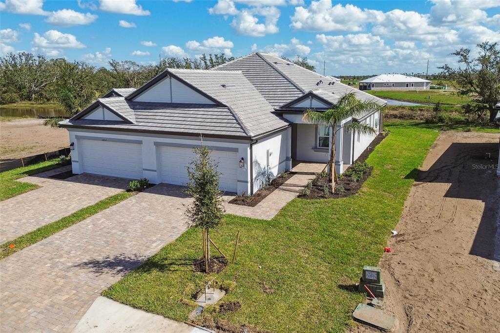 a aerial view of a house with a yard table and chairs