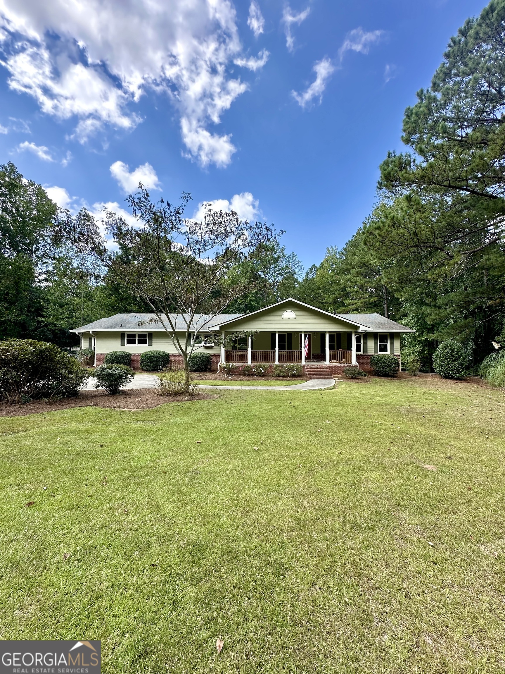 a front view of a house with a garden