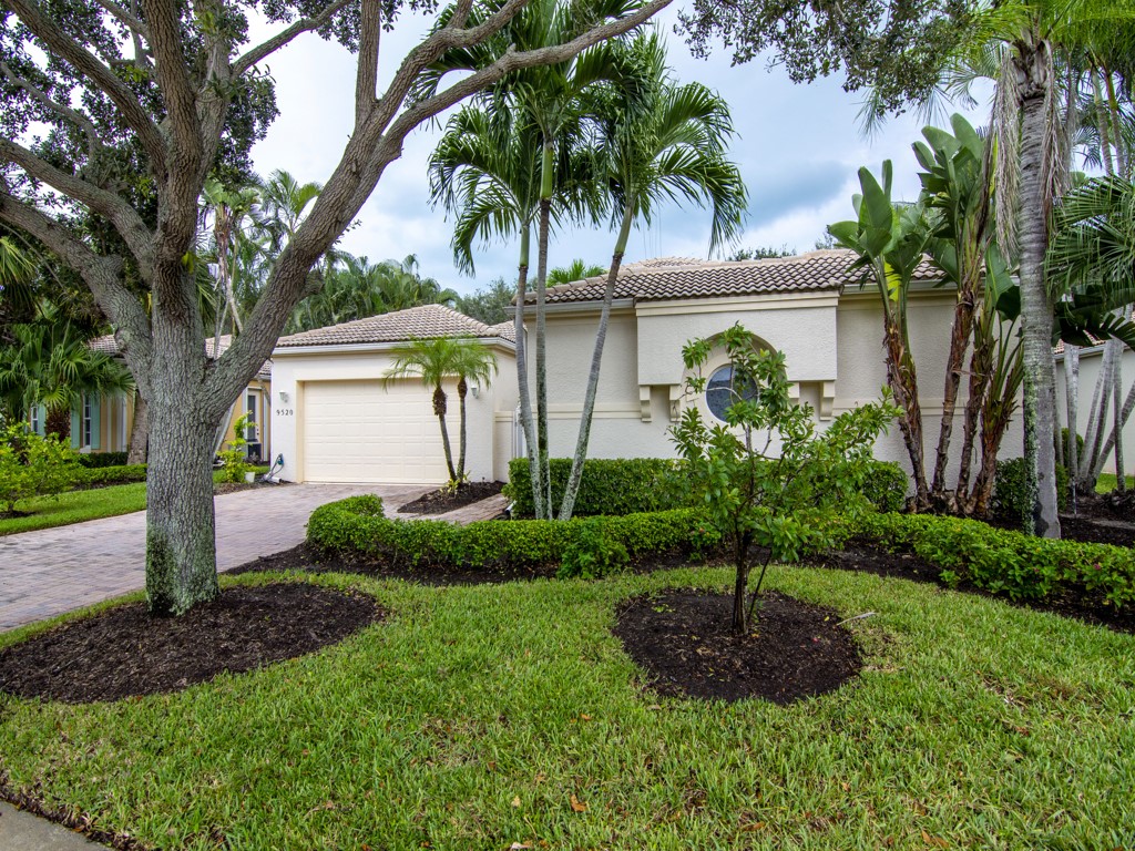 a front view of house with a garden