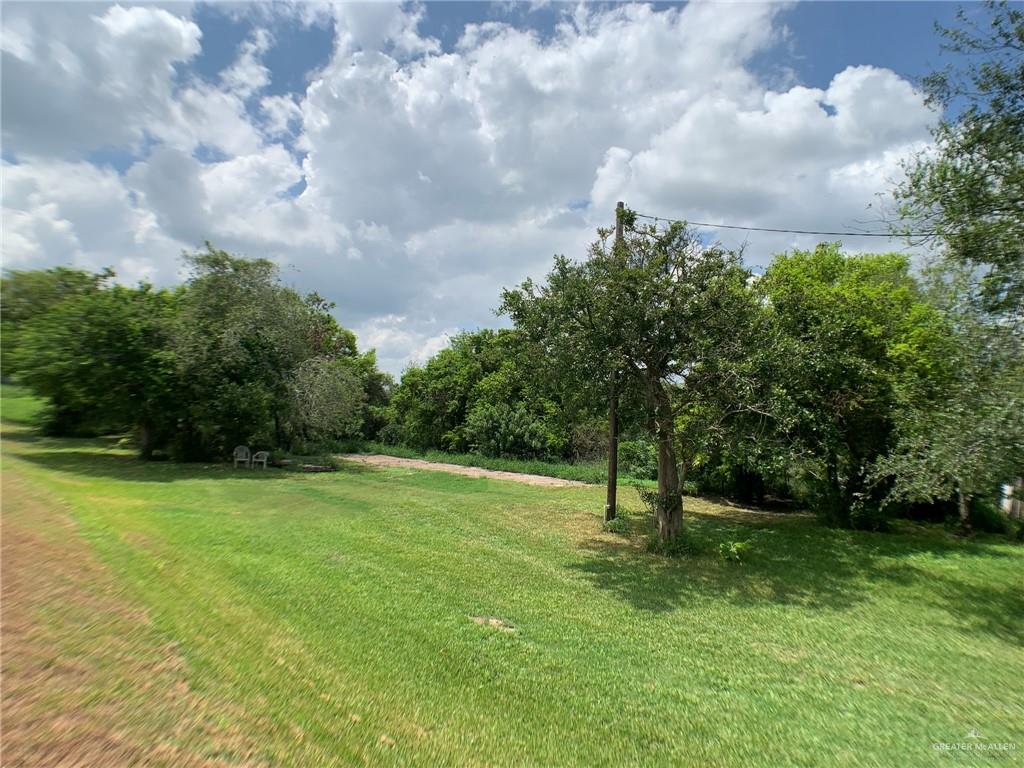 a view of field with trees in the background