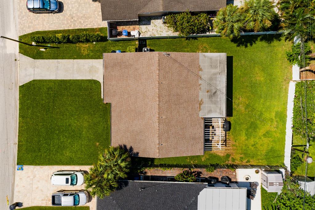 an aerial view of a house with a yard basket ball court and outdoor seating