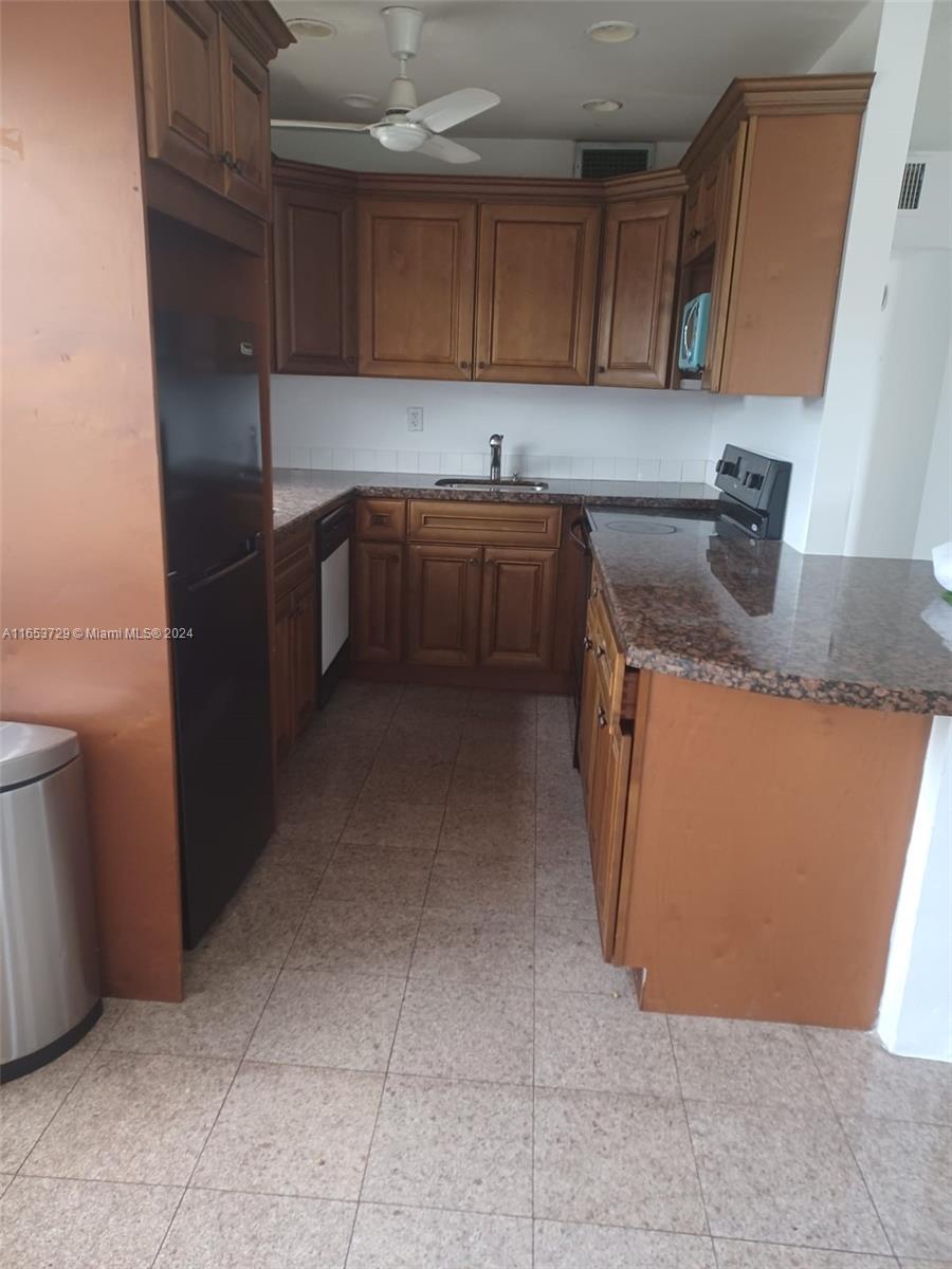 a kitchen with a sink a stove and cabinets