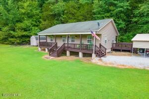 a view of a house with a yard porch and sitting area