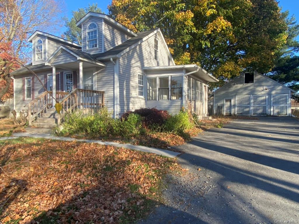 a front view of a house with a yard and outdoor seating