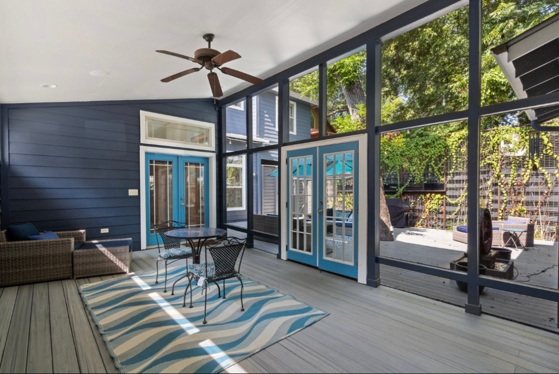 a view of a patio with table and chairs floor to ceiling window with wooden floor