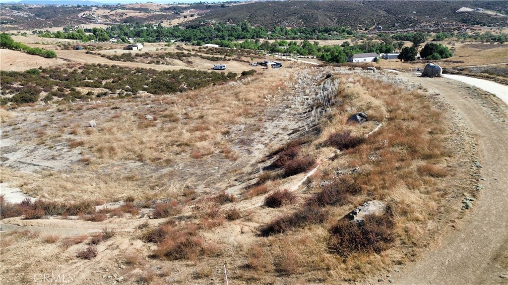 a view of a dry space with lots of trees