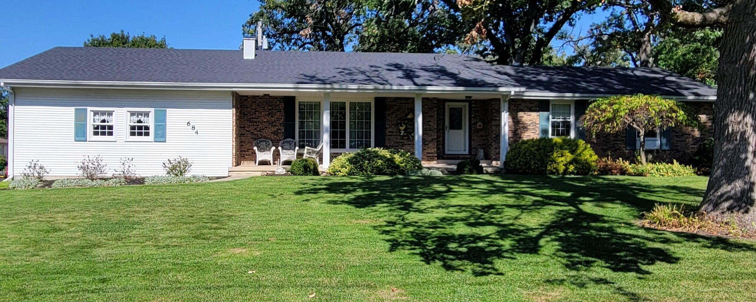 a front view of a house with garden