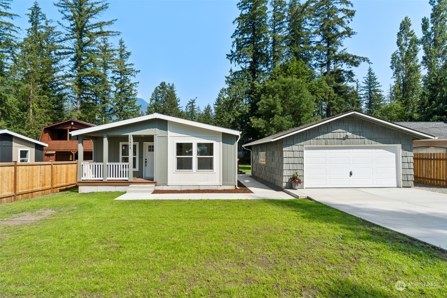 a front view of a house with a yard and trees