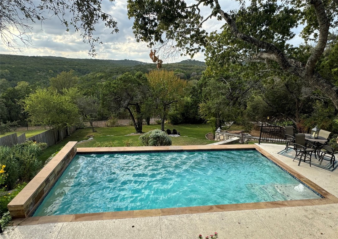 a view of a swimming pool with a patio