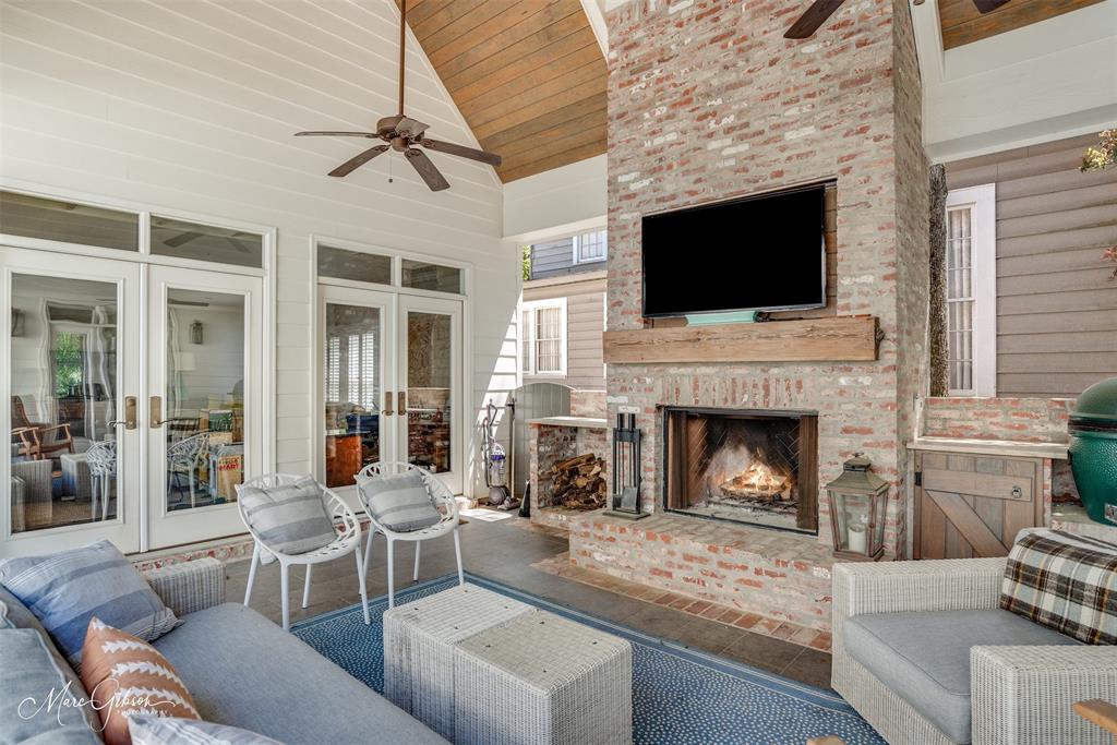 a living room with furniture a flat screen tv and a fireplace