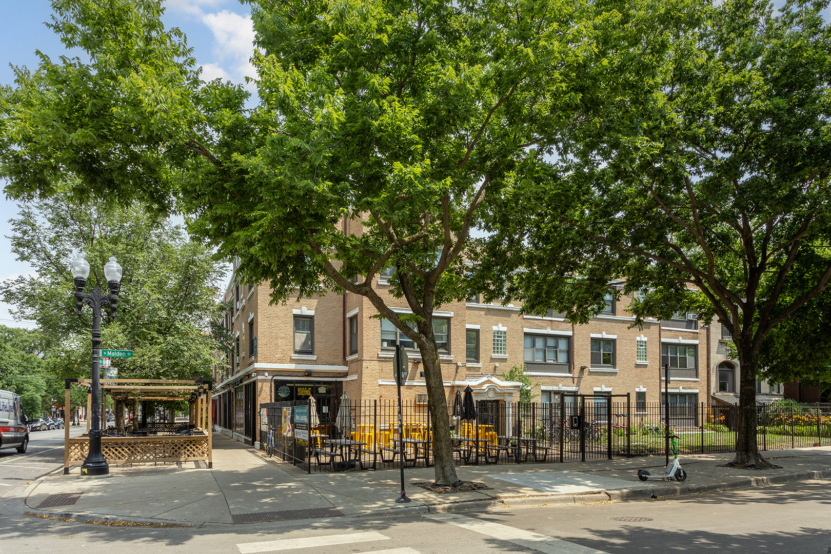 a front view of a residential apartment building with a yard