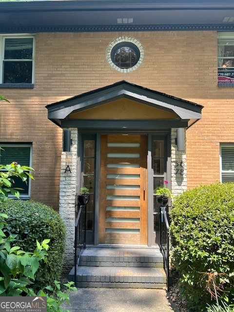 a front view of a house with plants