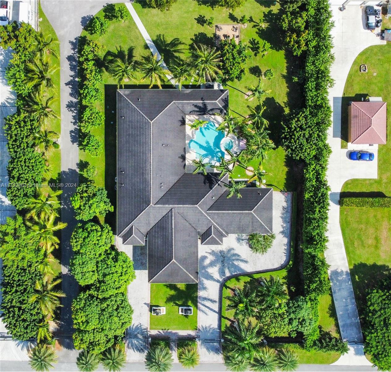 an aerial view of a house with a yard and garden