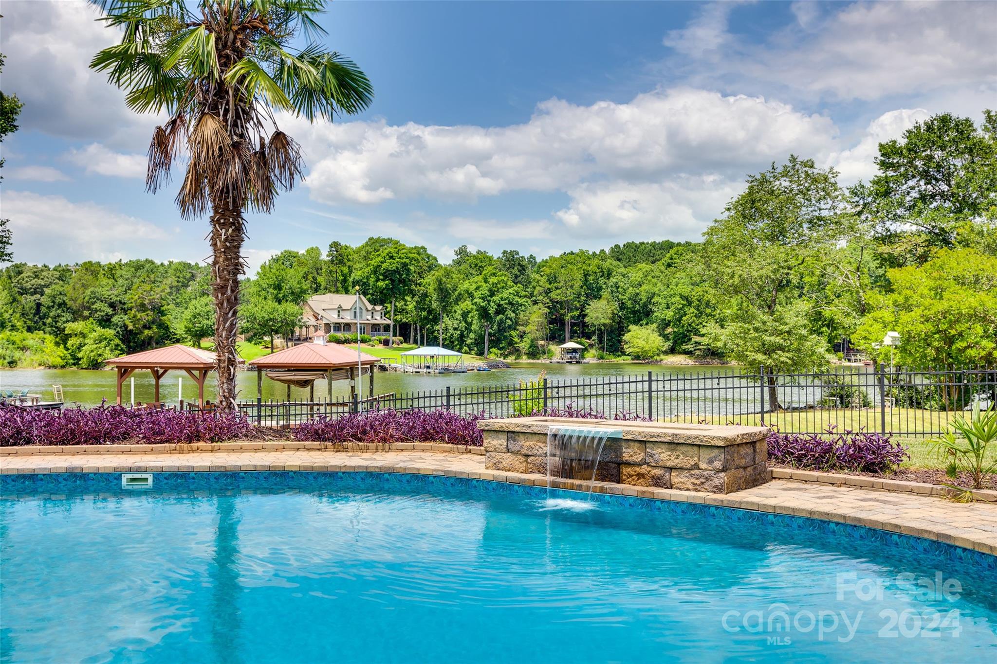 a view of swimming pool with outdoor seating and garden