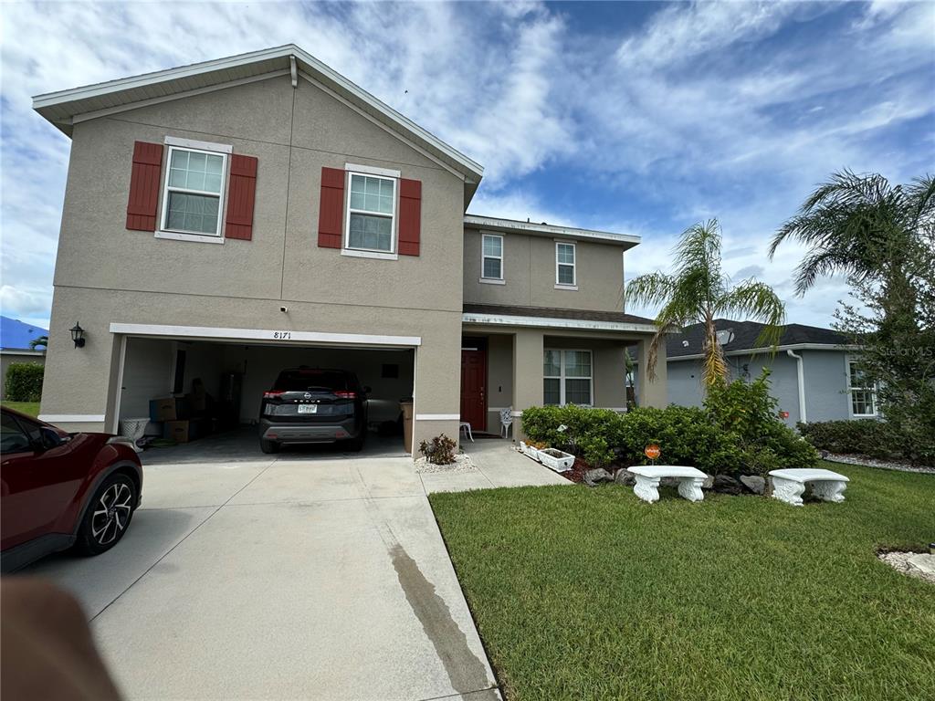 a front view of a house with a yard and garage