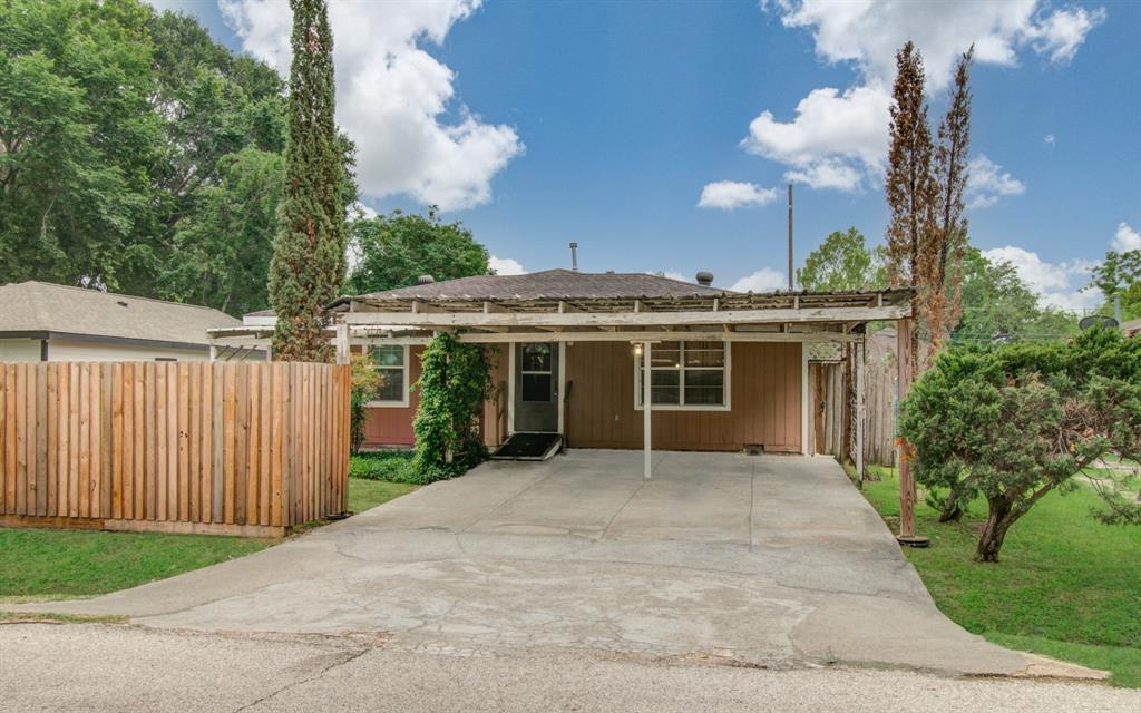 a view of a house with a yard and potted plants