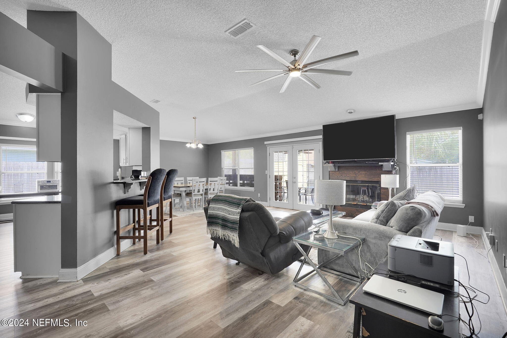 a living room with furniture a fireplace and a flat screen tv