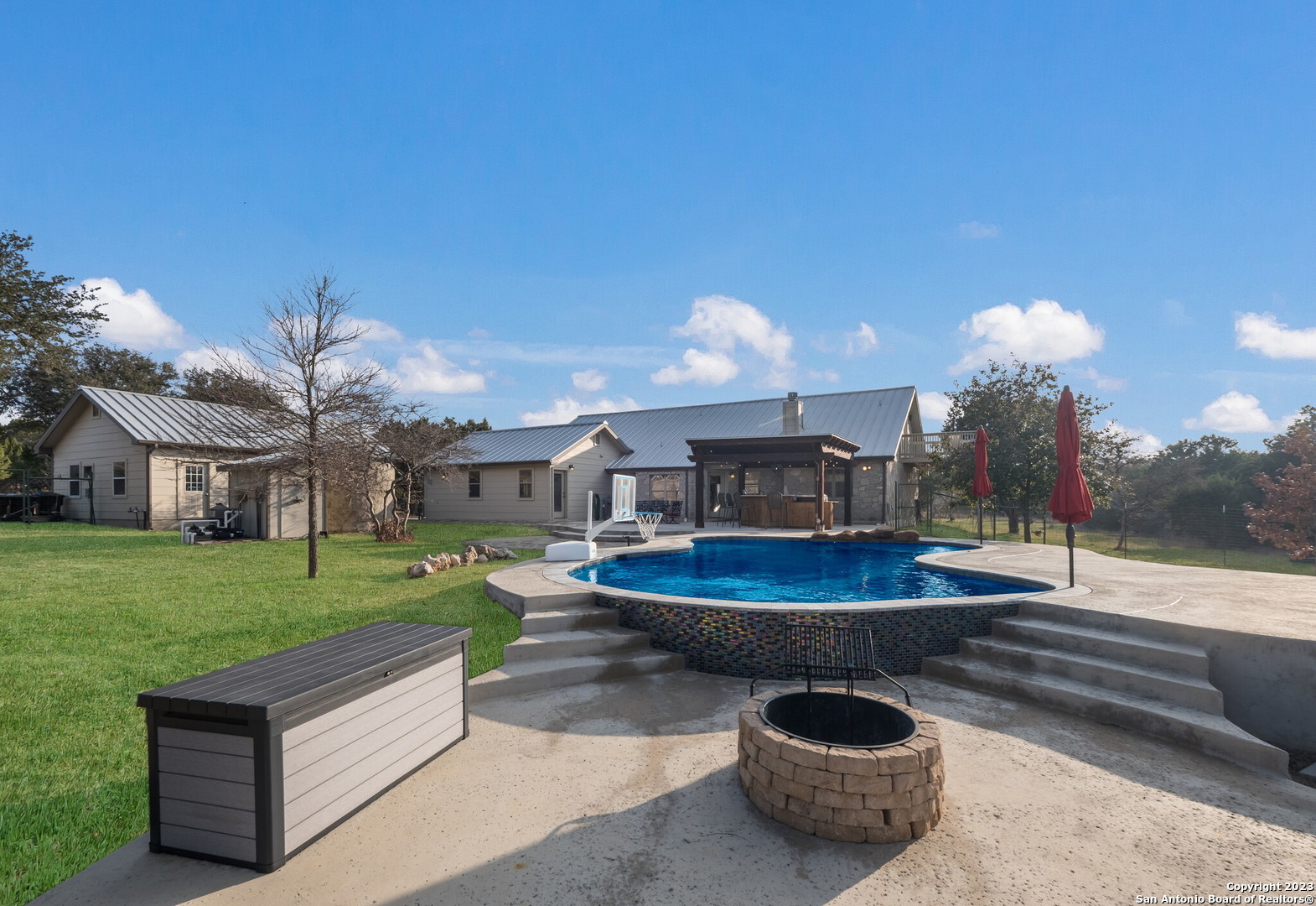 a backyard of a house with table and chairs