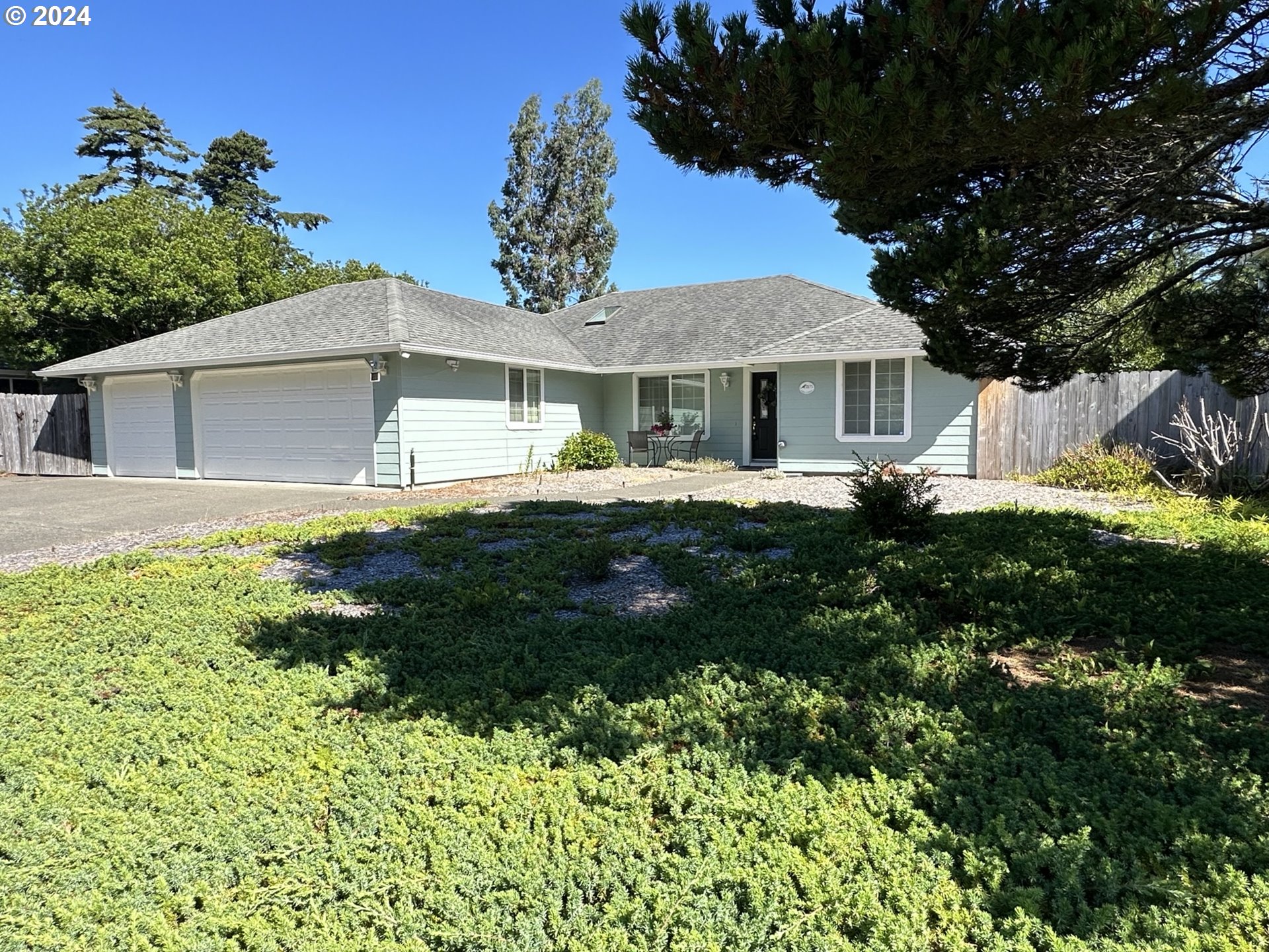 a front view of a house with a garden