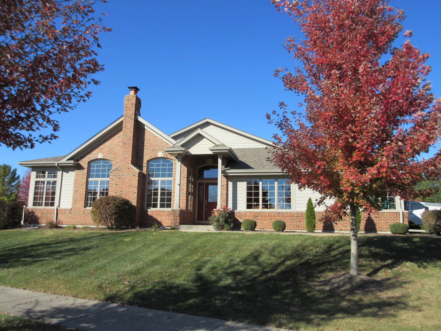 a front view of house with yard and green space