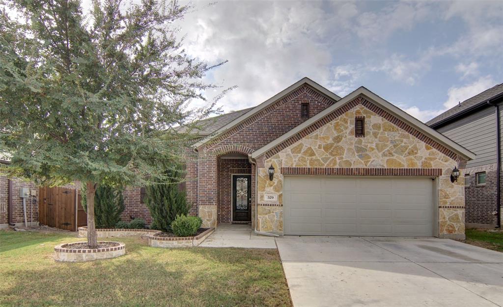 a front view of a house with a yard garage and outdoor seating