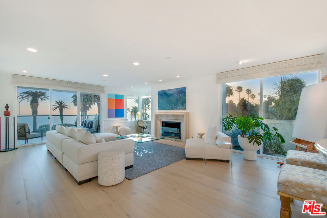 a living room with fireplace furniture dining table and a fireplace