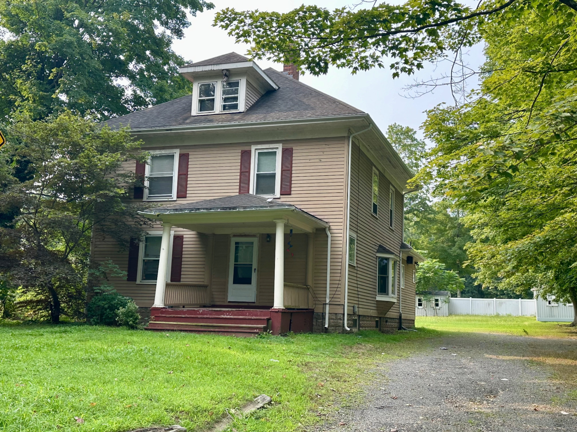 a view of a house with a yard and a tree