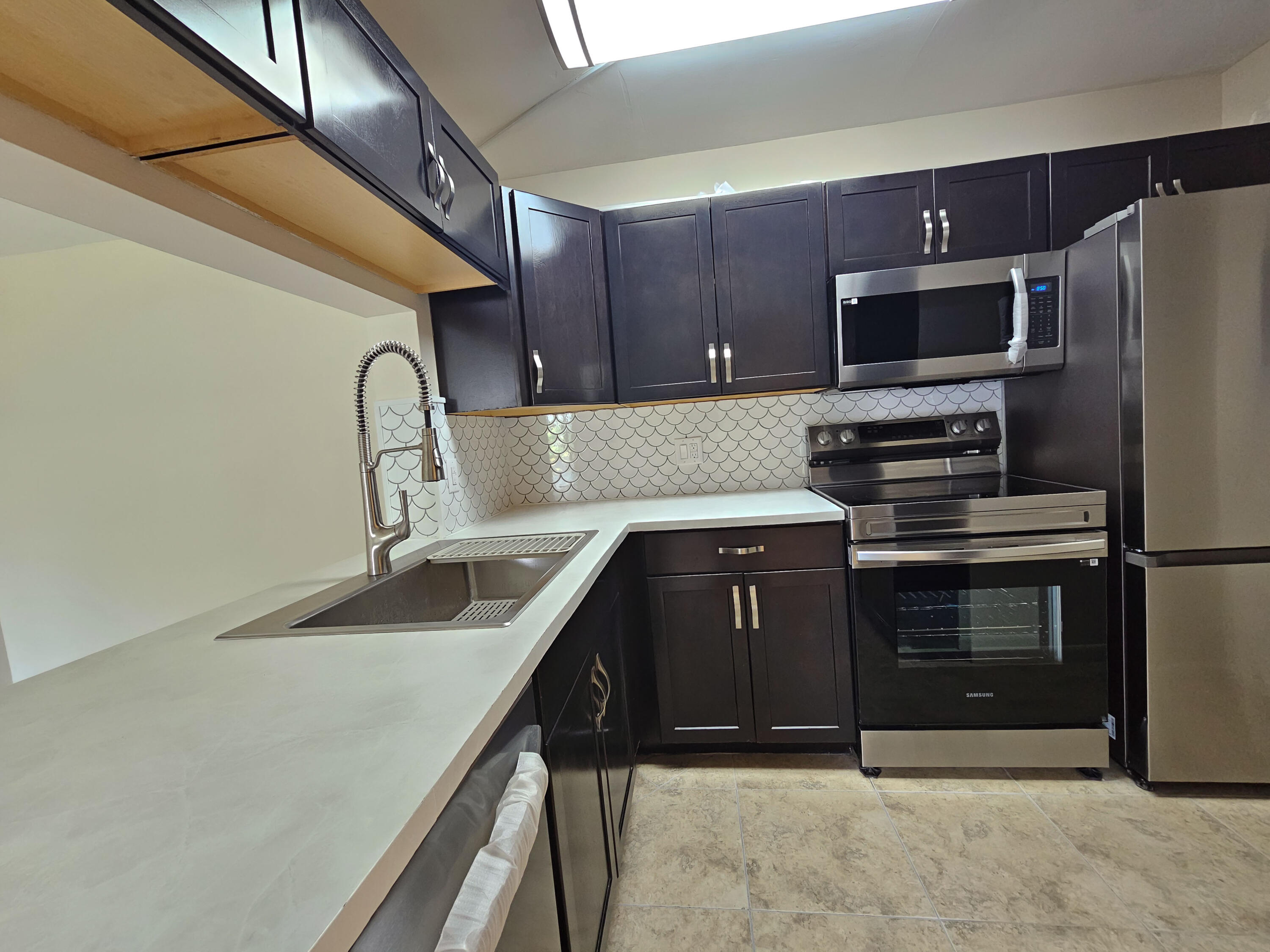 a kitchen with stainless steel appliances a sink stove and refrigerator