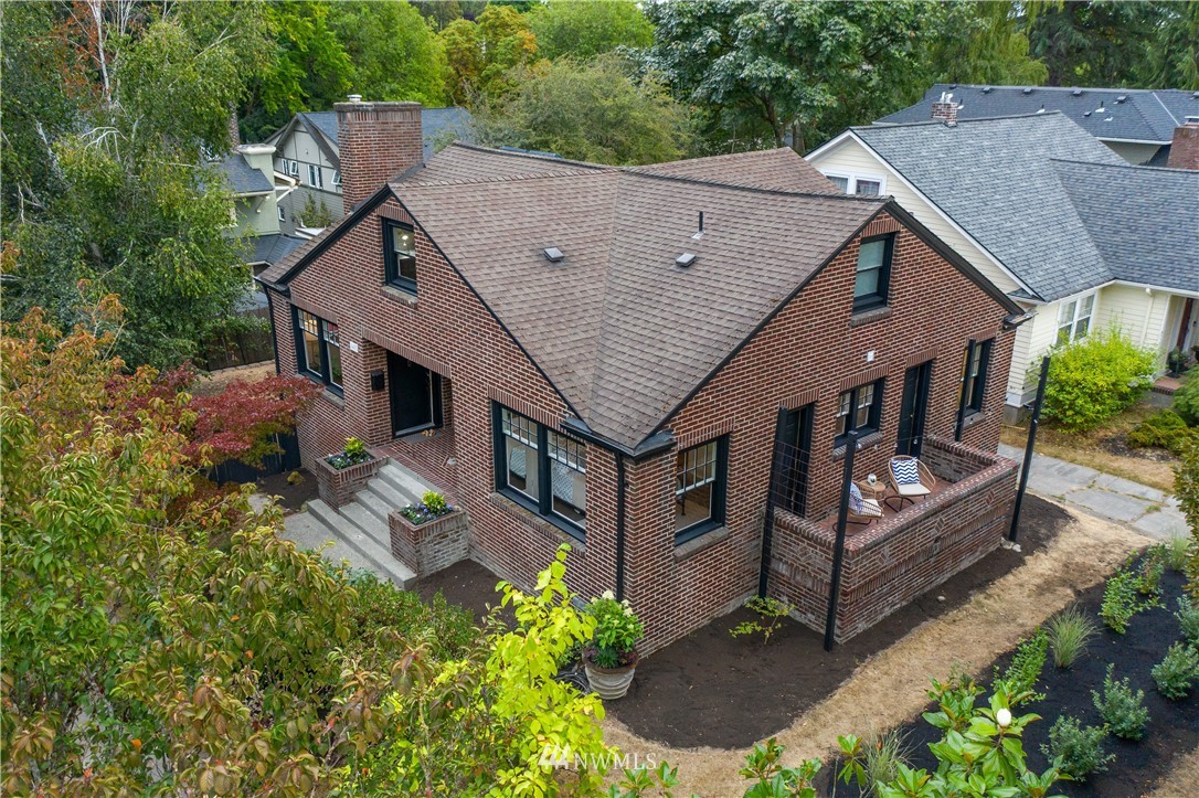 an aerial view of a house with balcony and trees