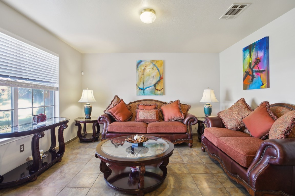 a living room with furniture a rug and a window