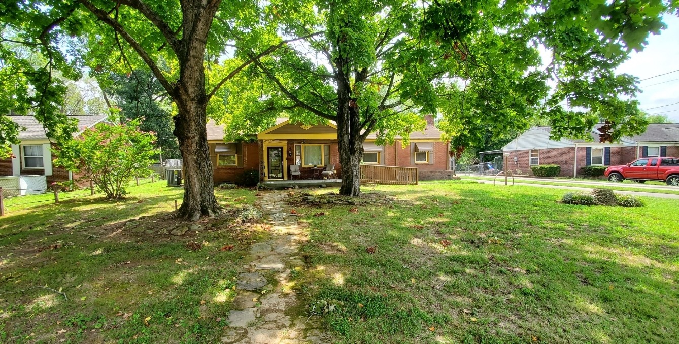 a front view of a house with a yard table and chairs