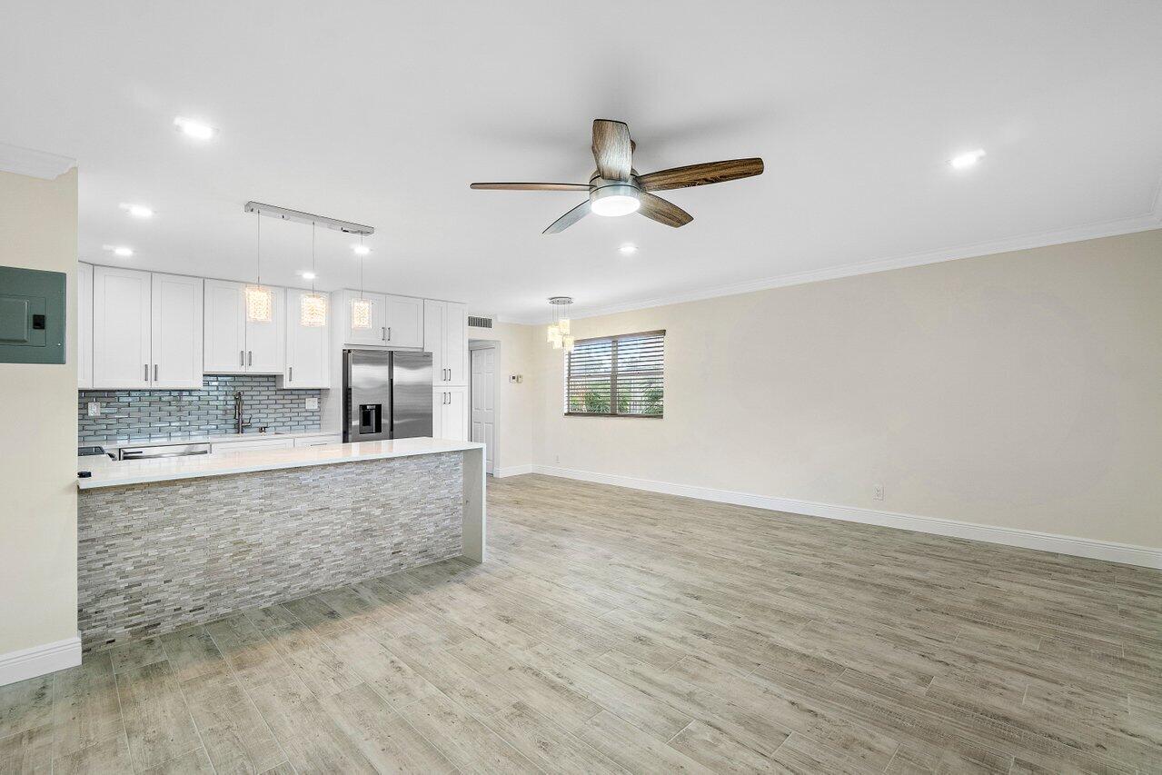 a view of kitchen with wooden floor and window