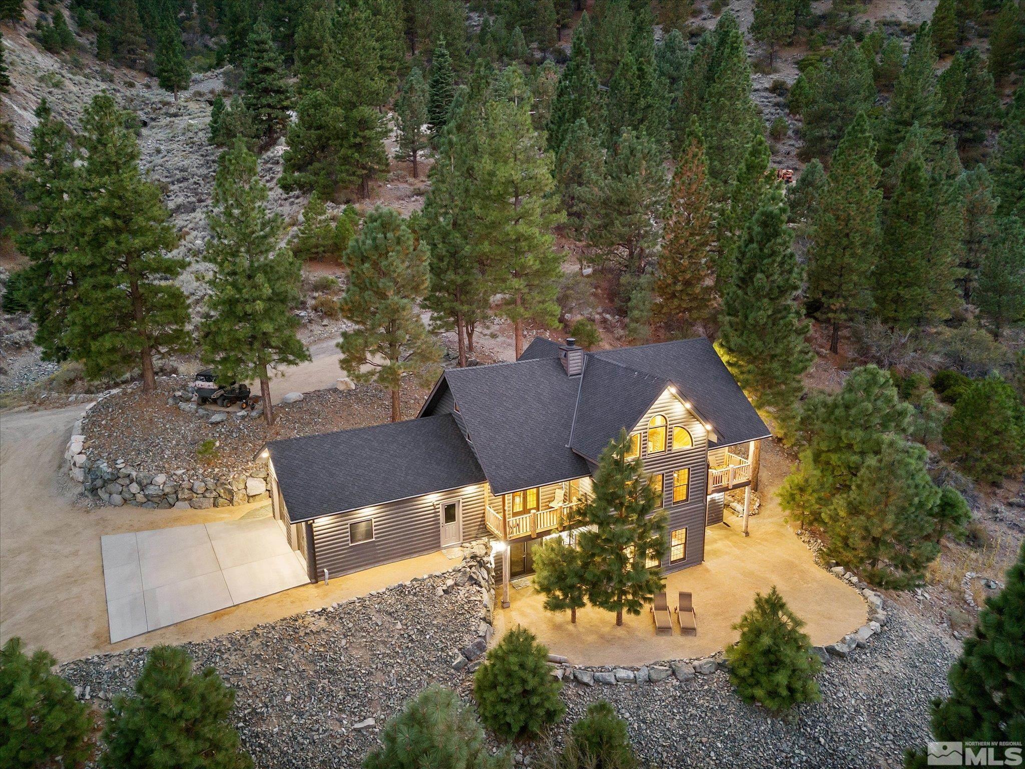 an aerial view of a house with a yard