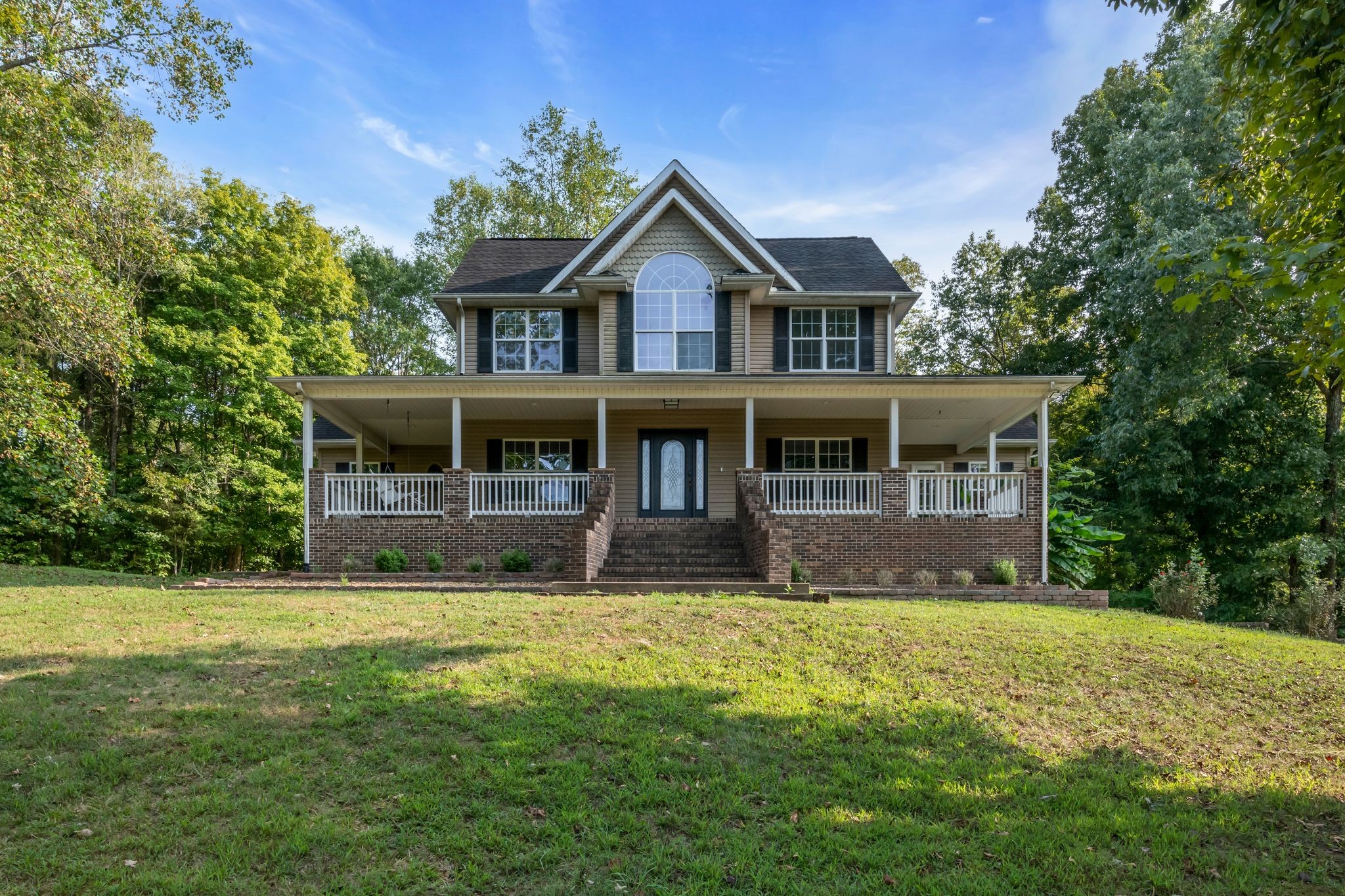 a front view of a house with a yard