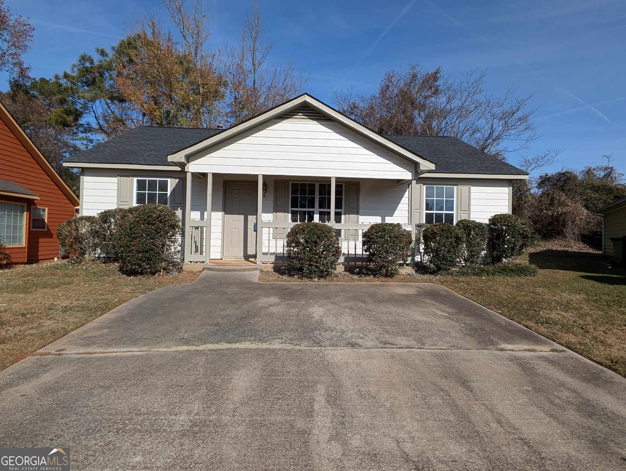 a front view of a house with a garden