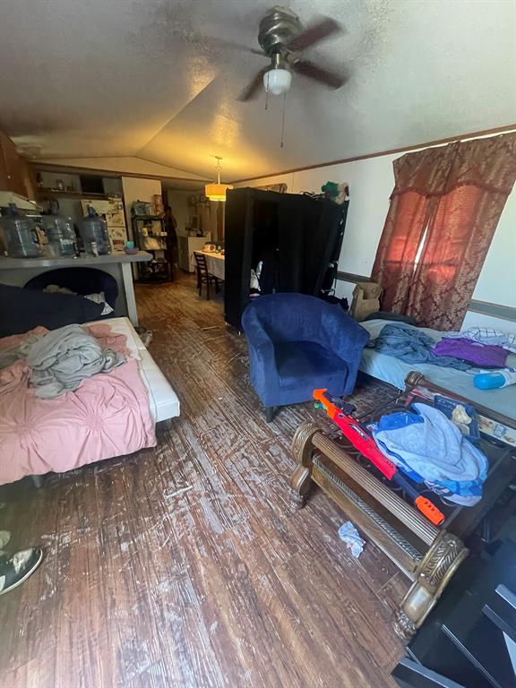 a bedroom with furniture and a wooden floor