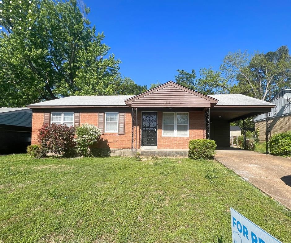 Ranch-style home with a carport and a front yard